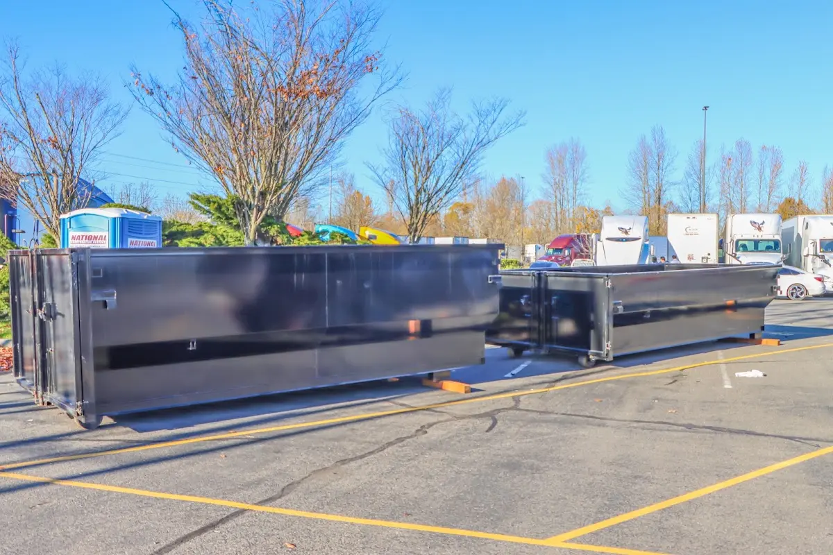 Professional dumpster rental service with roll-off container on residential driveway in Middle Smithfield